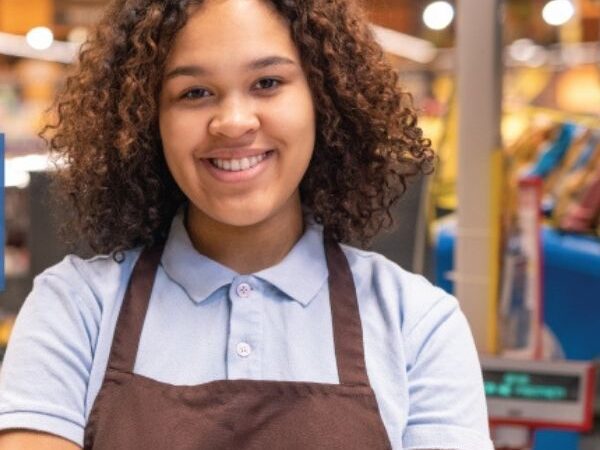 April Blog feature image of happy young black girl with the arms crossed