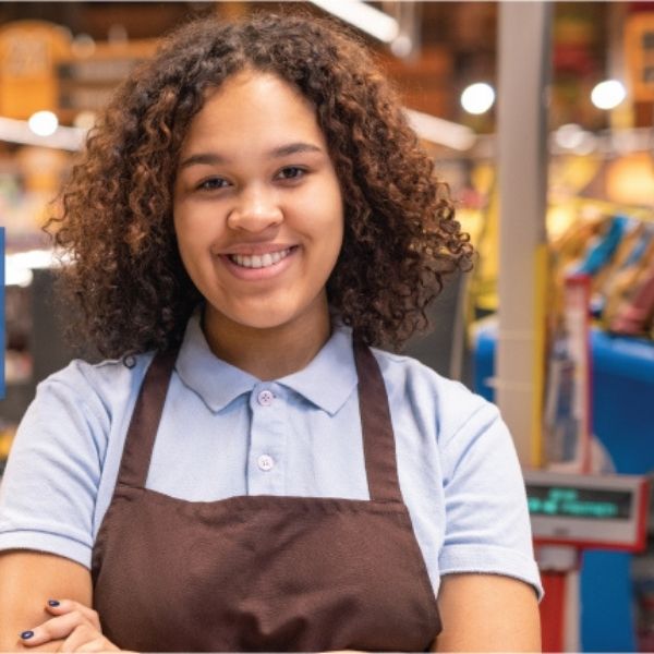 April Blog feature image of happy young black girl with the arms crossed