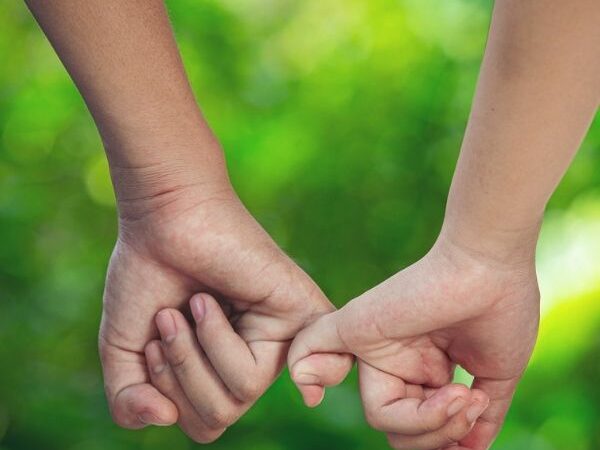 February 2021 Blog feature image of two hands with holding pinky fingers