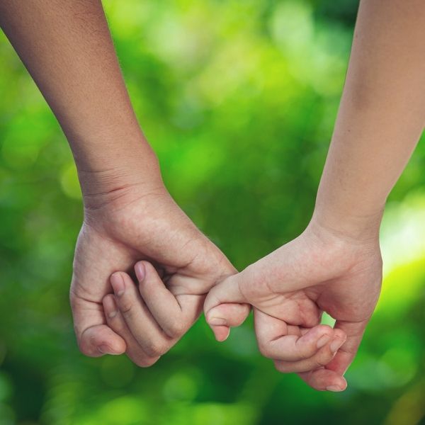 February 2021 Blog feature image of two hands with holding pinky fingers