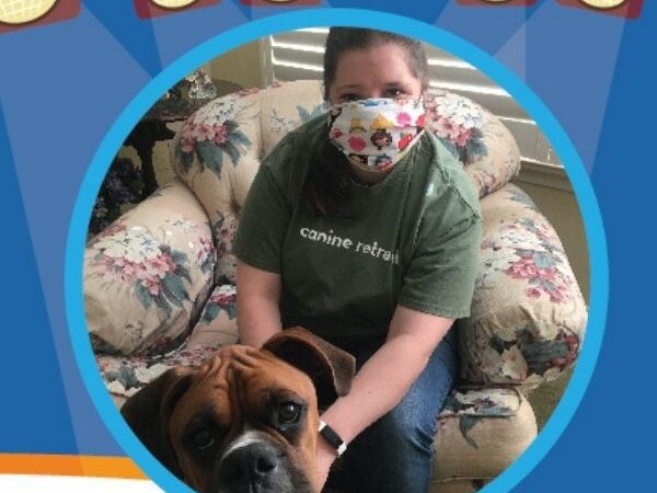 March Blog feature image of woman sitting with her boxer dog