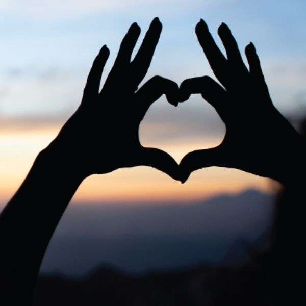 October 2020 blog feature image of two hands making a heart shape with a sunset in the background